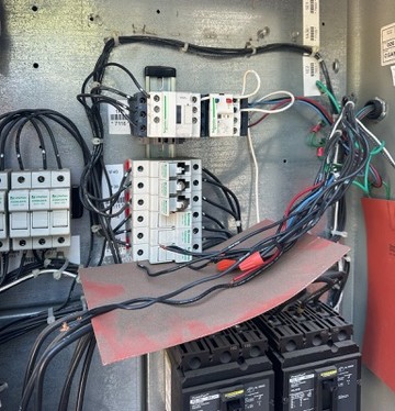 Commercial HVAC technician inspecting control wiring in Dallas Fort Worth